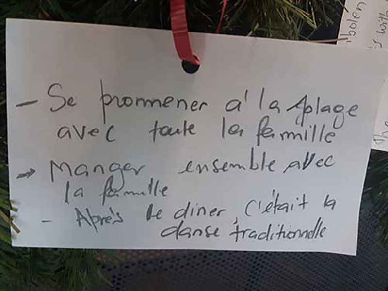 White paper hung with red ribbon.