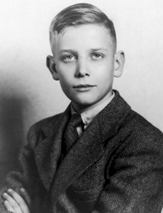 Portrait of a young blond boy wearing a suit.