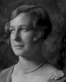 Old portrait of a young woman wearing pearls and looking off to her side.