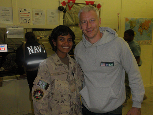 Smiling young lady wearing a Canadian Armed Forces uniform stands next to a famous news anchorman - Anderson Cooper.