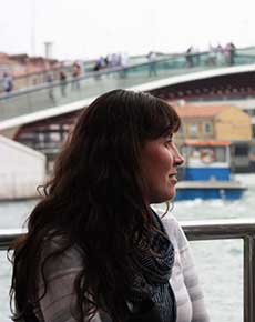 Profile of young woman, looking off into the distance.