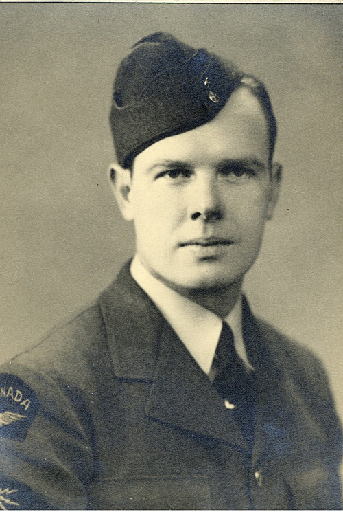 Portrait of a young man in a military uniform and hat.