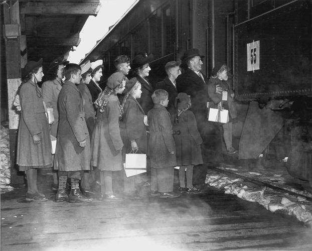 Van Helvert children boarding a train at Pier 21. Canadian National Railway X32173