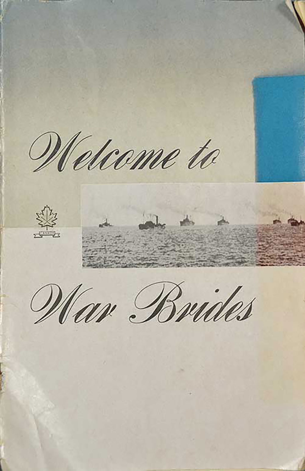 An old creased pamphlet with images of ships on it and a small drawing of a maple leaf.