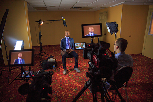 A man is being interviewed on camera.